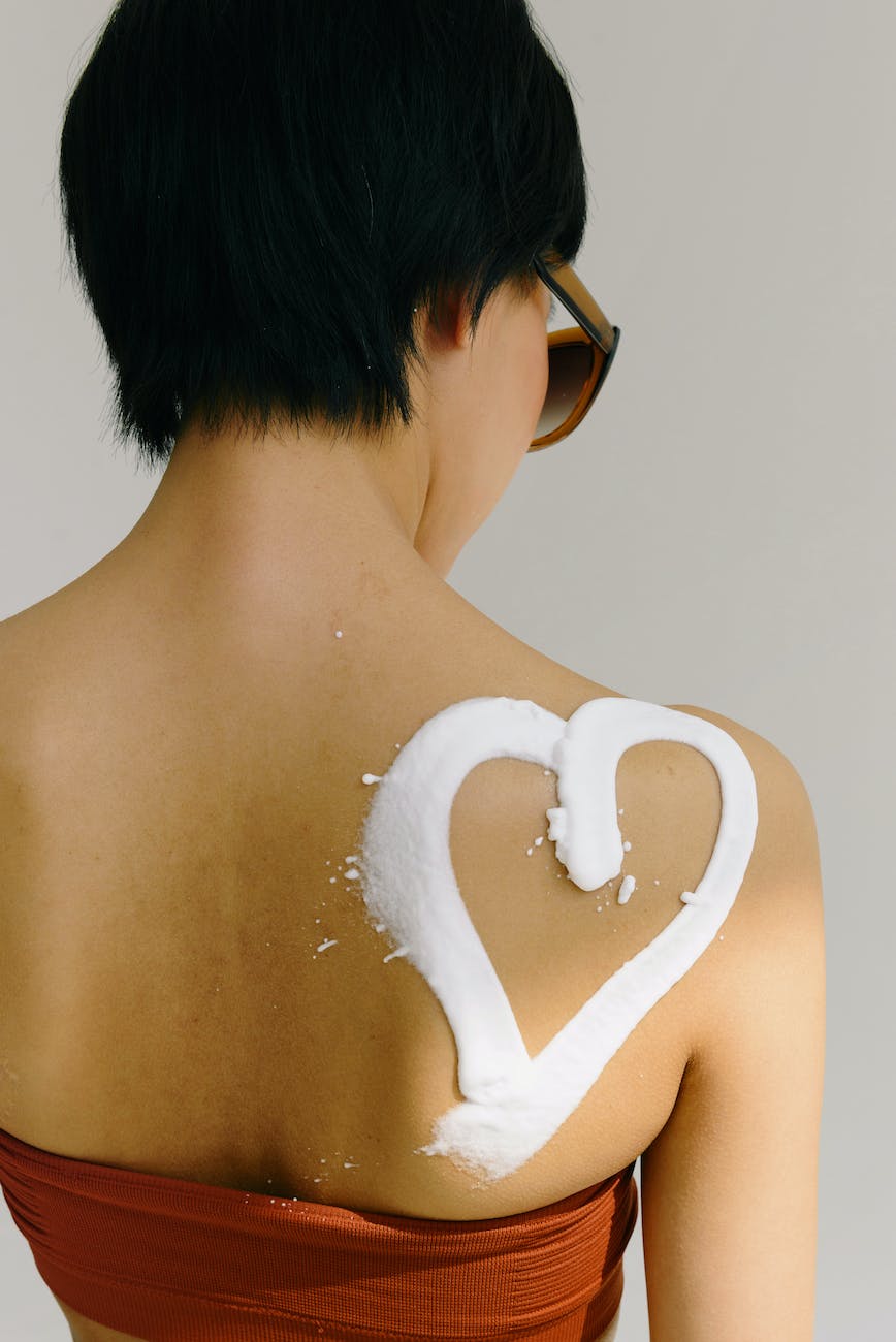 woman with a heart painted with sunscreen on her back